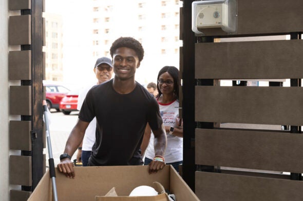 Sean Ikerodah (center) followed his father Prince (left) and mother Glory (right) and is studying at UIC. (Photo: Jenny Fontaine/UIC)