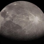 A gray moon speckled with craters against a black background.