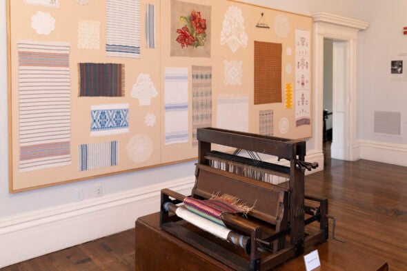 A historic loom sits among centuries-old textiles at the Hull-House Museum.