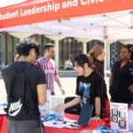 Students with UIC Student Leadership and Civic Engagement handing out voting information at the east side of campus Sept. 17, 2024. (Jenny Fontaine / UIC)