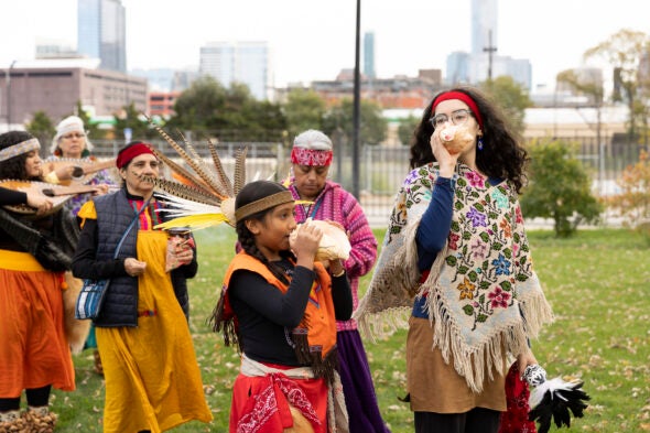 Members of Tiahui Chicago dance to bless marigold flowers.