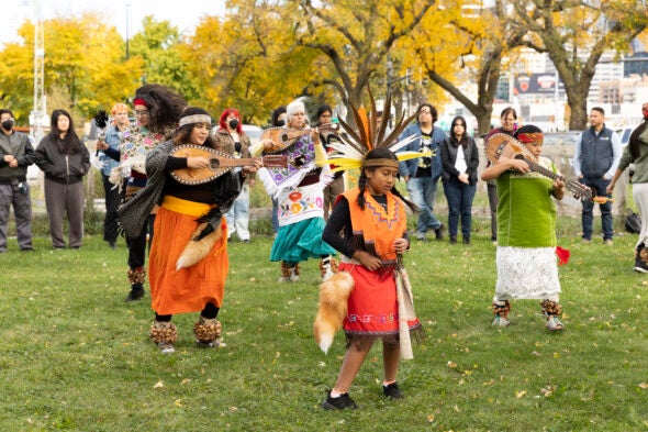 Members of Tiahui Chicago dance to bless marigold flowers.