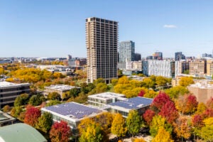 An aerial view of the University of Illinois Chicago campus, with tall buildings and colorful autumn trees