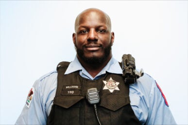 Officer Tim Williams smiles at the camera.