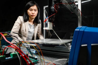 A woman works with engineering equipment in a laboratory.