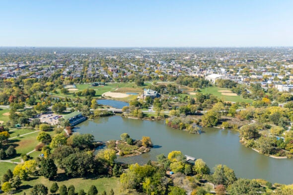 An aerial shot of a park with a large lagoon in the foreground.