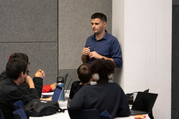 Avi Mayerhoff speaks to students in class.