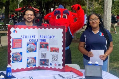 Kayla Pilgrim (SAC Director of Communications) joined by Jair Alvarez (SAC Co-President) at the Fall ‘23 Involvement Fair promoting the UIC Student Advocacy Coalition