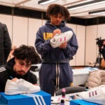 two basketball players Painting sneakers